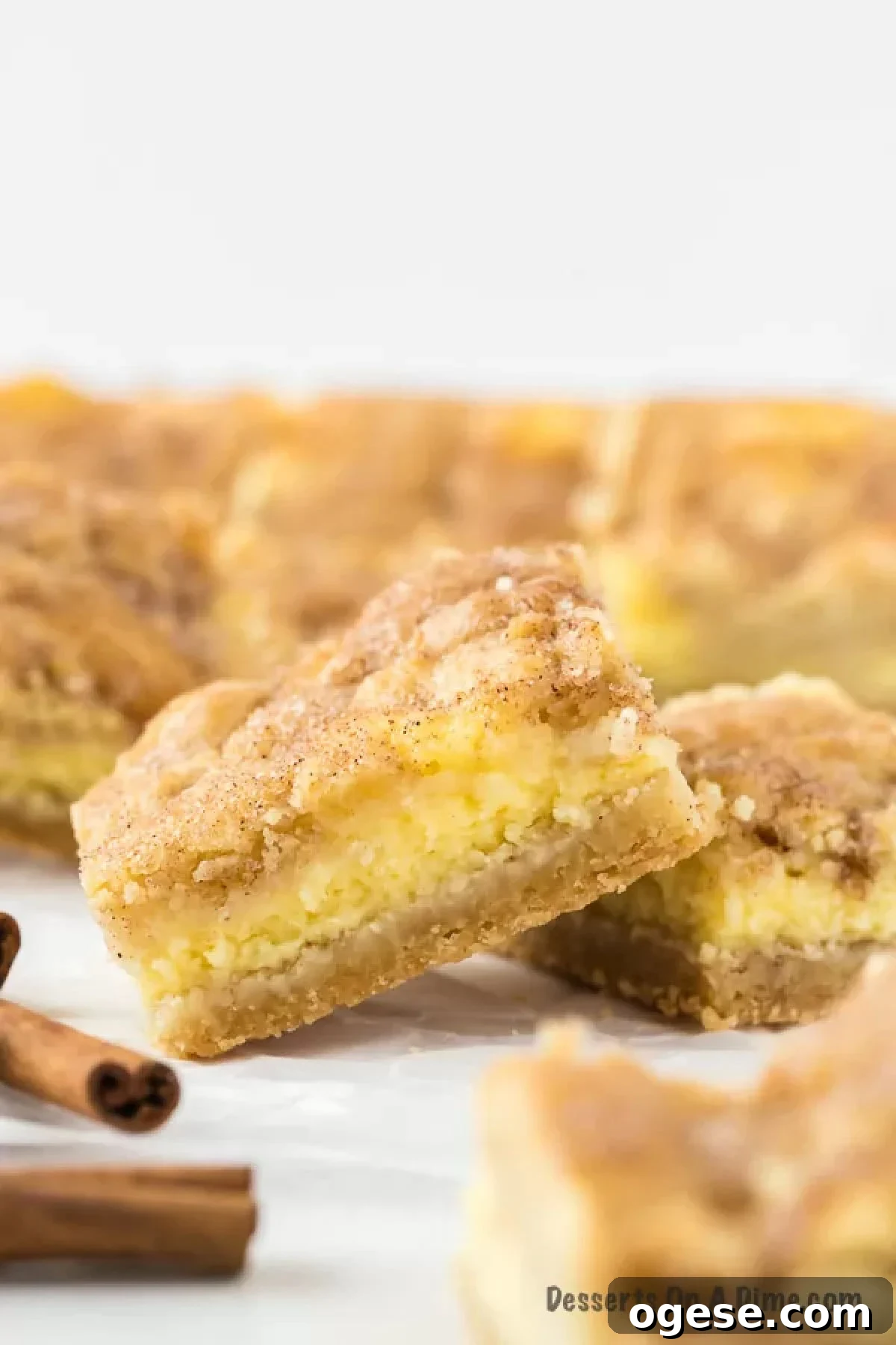 Snickerdoodle cheesecake bars cut into squares. 