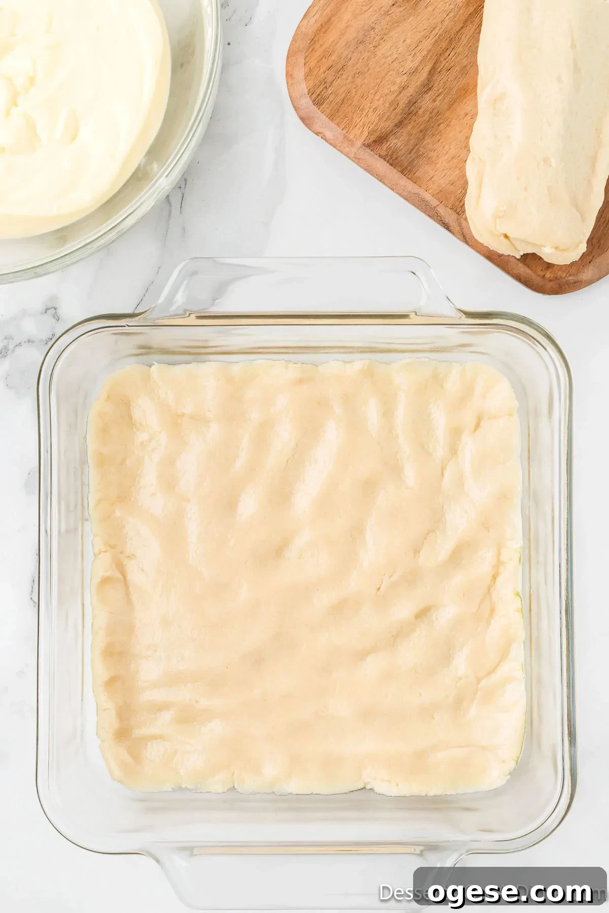 Sugar cookie dough pressed into a baking dish. 