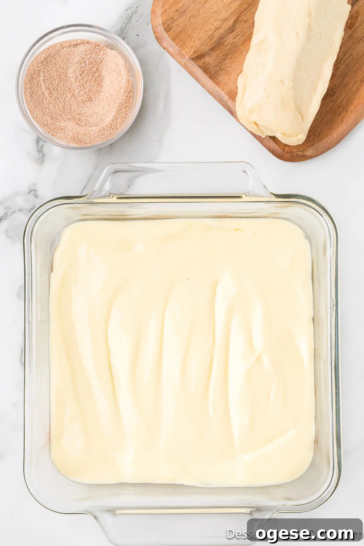 Cheesecake filling spread on top of dough. 