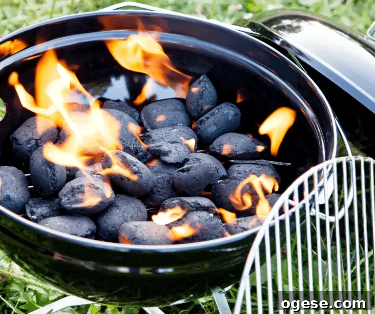 Start a Charcoal Grill Without Chimney or Lighter Fluid: 7 Safe Methods 3 lit charcoal inside of a black weber kettle grill with a grill grate leaning next to it