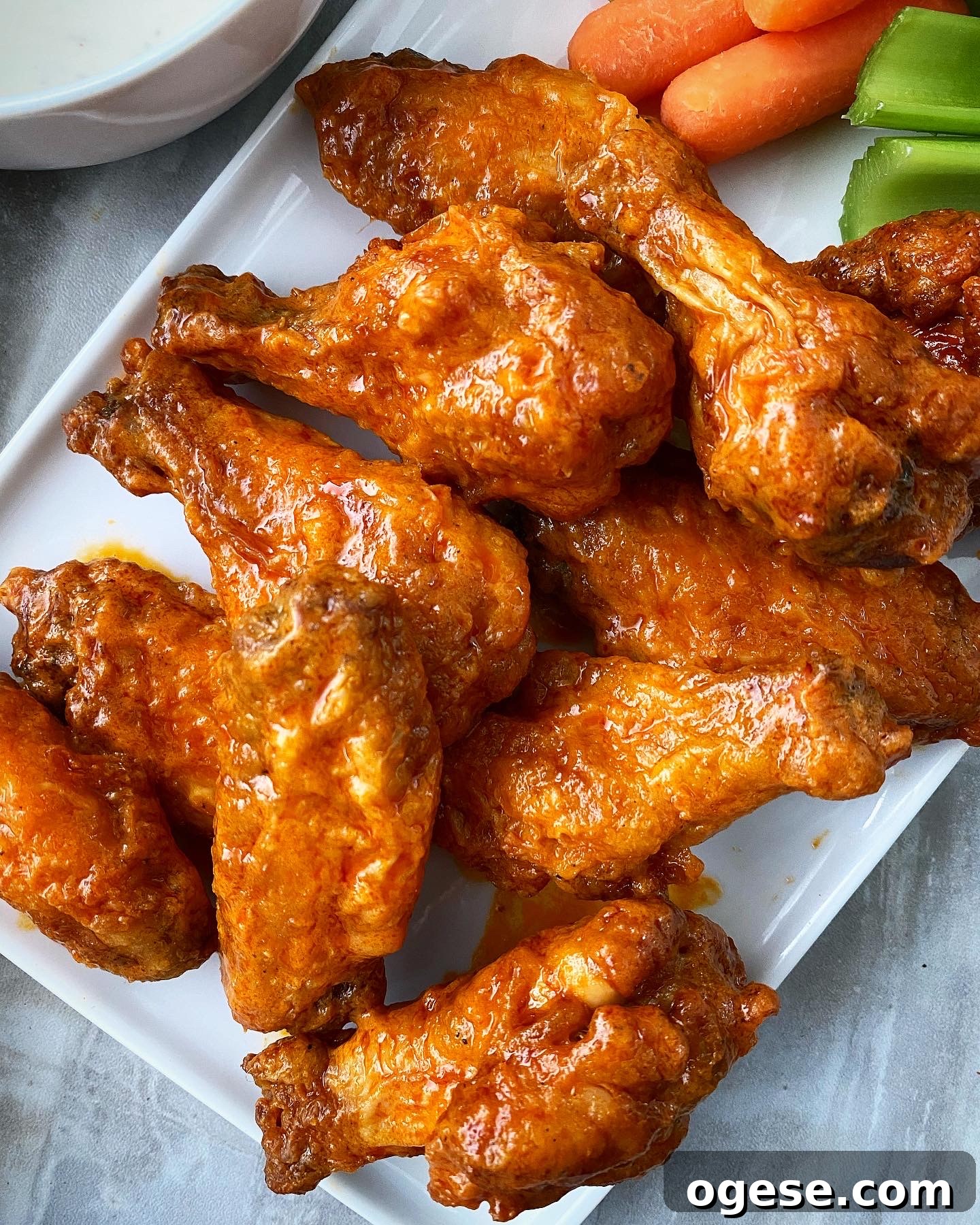 close up of air fryer buffalo chicken wings on a white plate