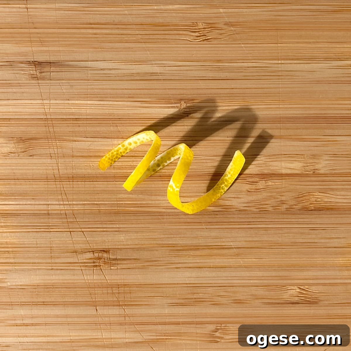 Classic Rock Shandy Recipe: Refreshing Lemon Beer Cocktail Guide 12 A lemon peel twisty on a wooden chopping board.
