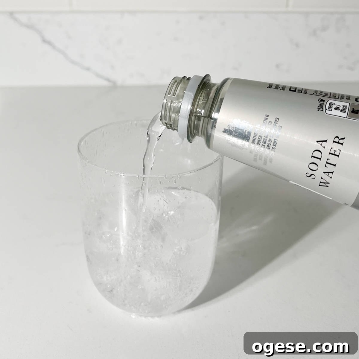 Classic Rock Shandy Recipe: Refreshing Lemon Beer Cocktail Guide 5 Adding soda water to the glass.