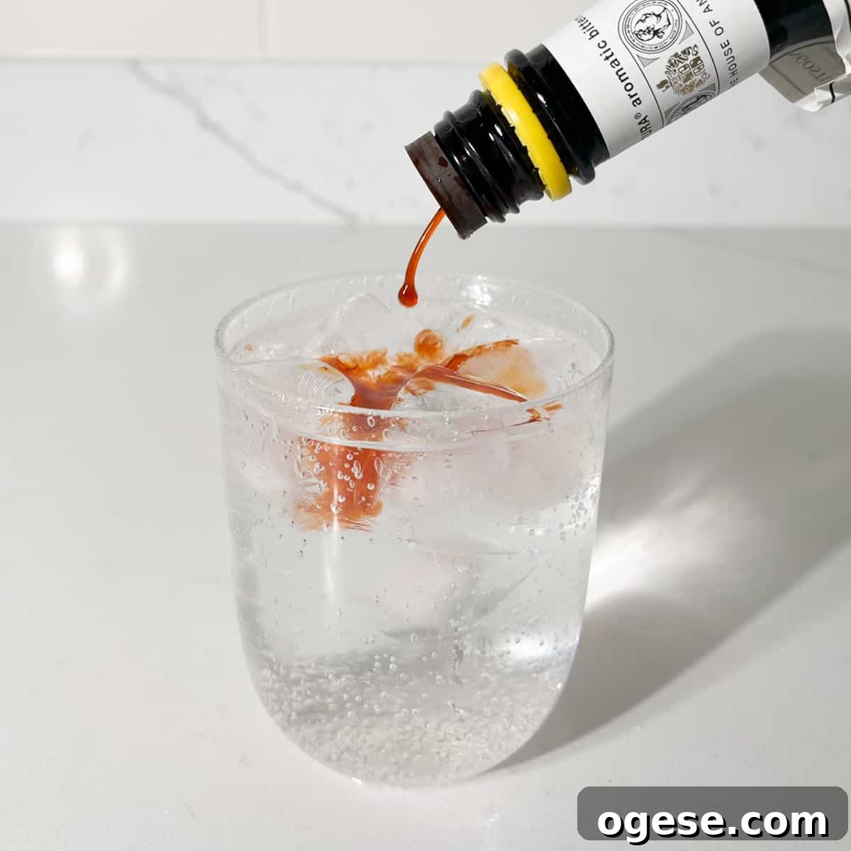Classic Rock Shandy Recipe: Refreshing Lemon Beer Cocktail Guide 6 Adding Angostura bitters to the rock shandy.