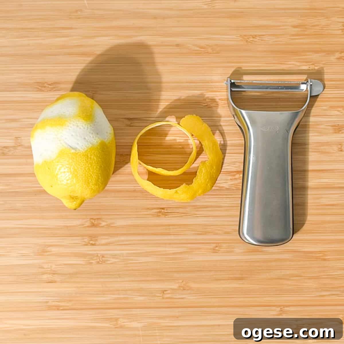 Classic Rock Shandy Recipe: Refreshing Lemon Beer Cocktail Guide 9 Peeling a long length of lemon peel with a peeler.