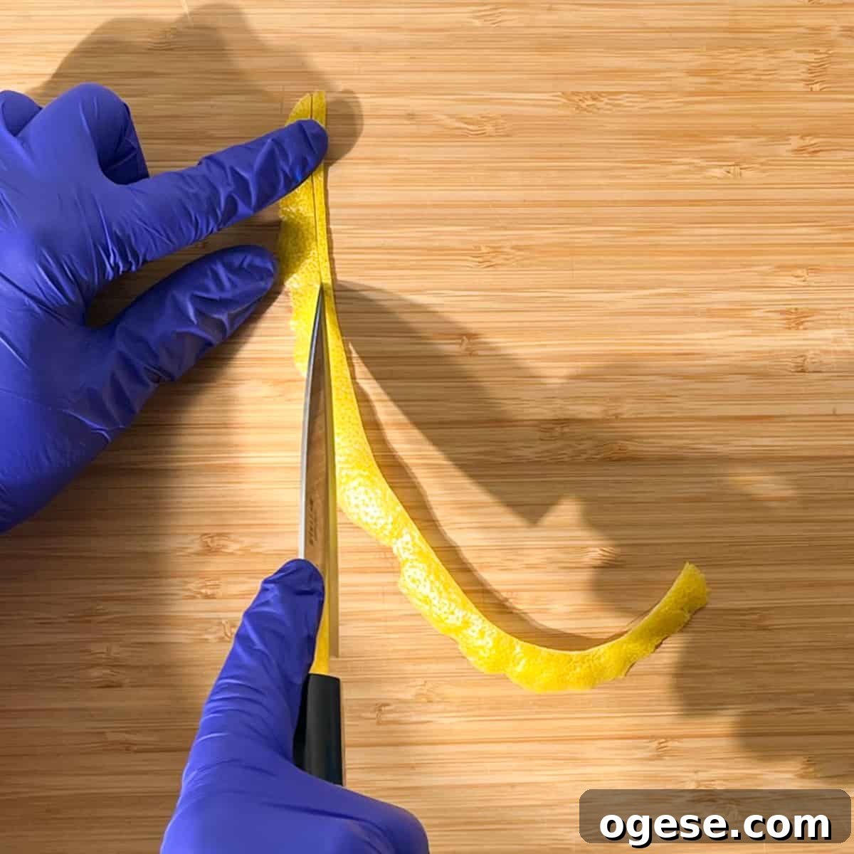 Classic Rock Shandy Recipe: Refreshing Lemon Beer Cocktail Guide 10 Slicing a long strip of lemon peel for the lemon peel twisty to go on the rock shandy glass.