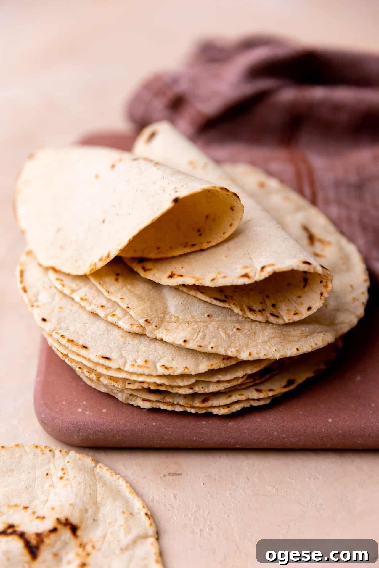 How to Make Authentic Homemade Corn Tortillas at Home 2 Stack of homemade corn tortillas folded over.