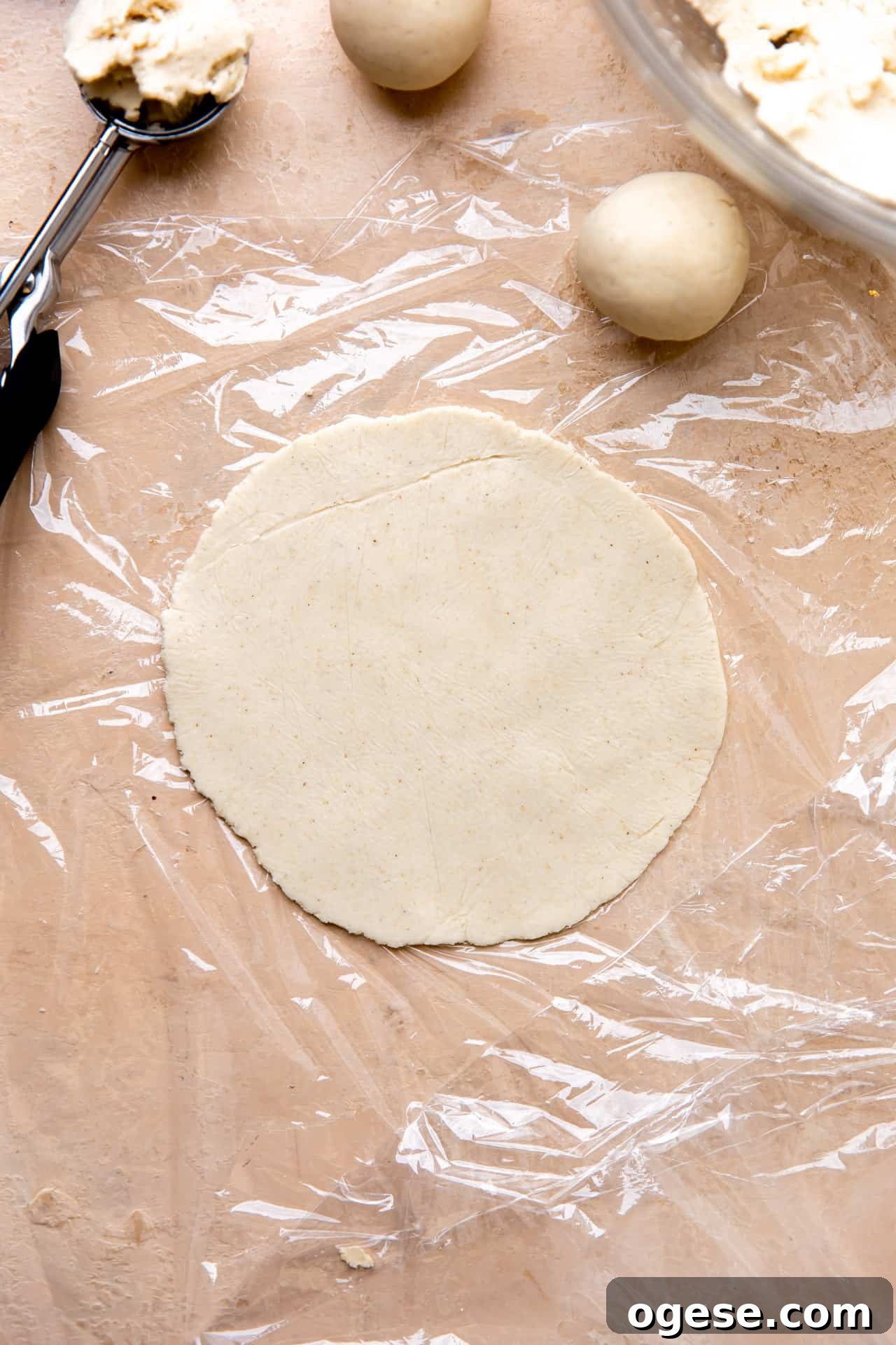 How to Make Authentic Homemade Corn Tortillas at Home 7 Corn tortilla masa dough pressed into a circle for cooking.