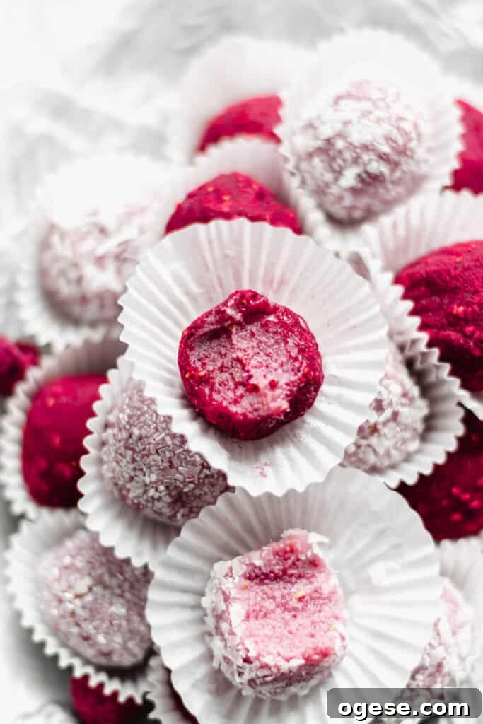 Close up shot of a raspberry brigadeiro with a bite removed