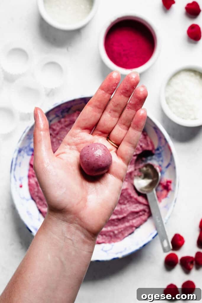 Rolled and smooth ball of fudge sits in the palm of a hand