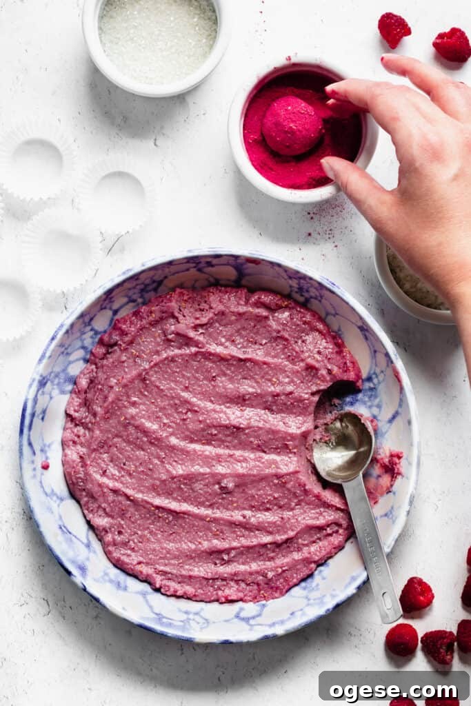 The rolled ball of fudge gets tossed in freeze dried raspberry powder