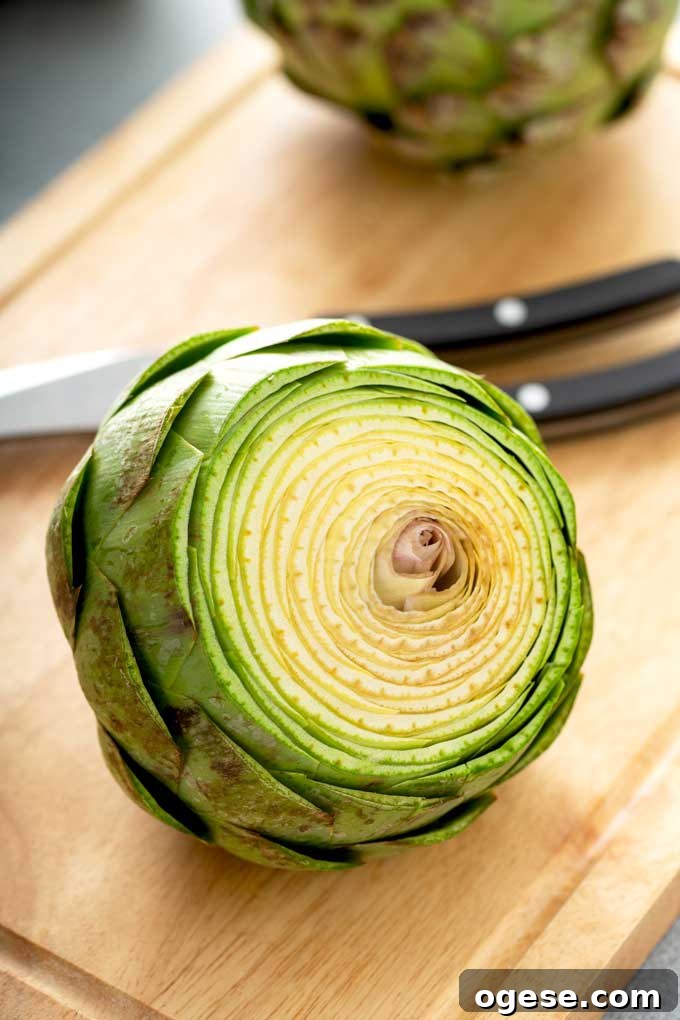 How to Cook Artichokes: Steamed and Roasted Methods 8 Trimmed artichoke on a cutting board