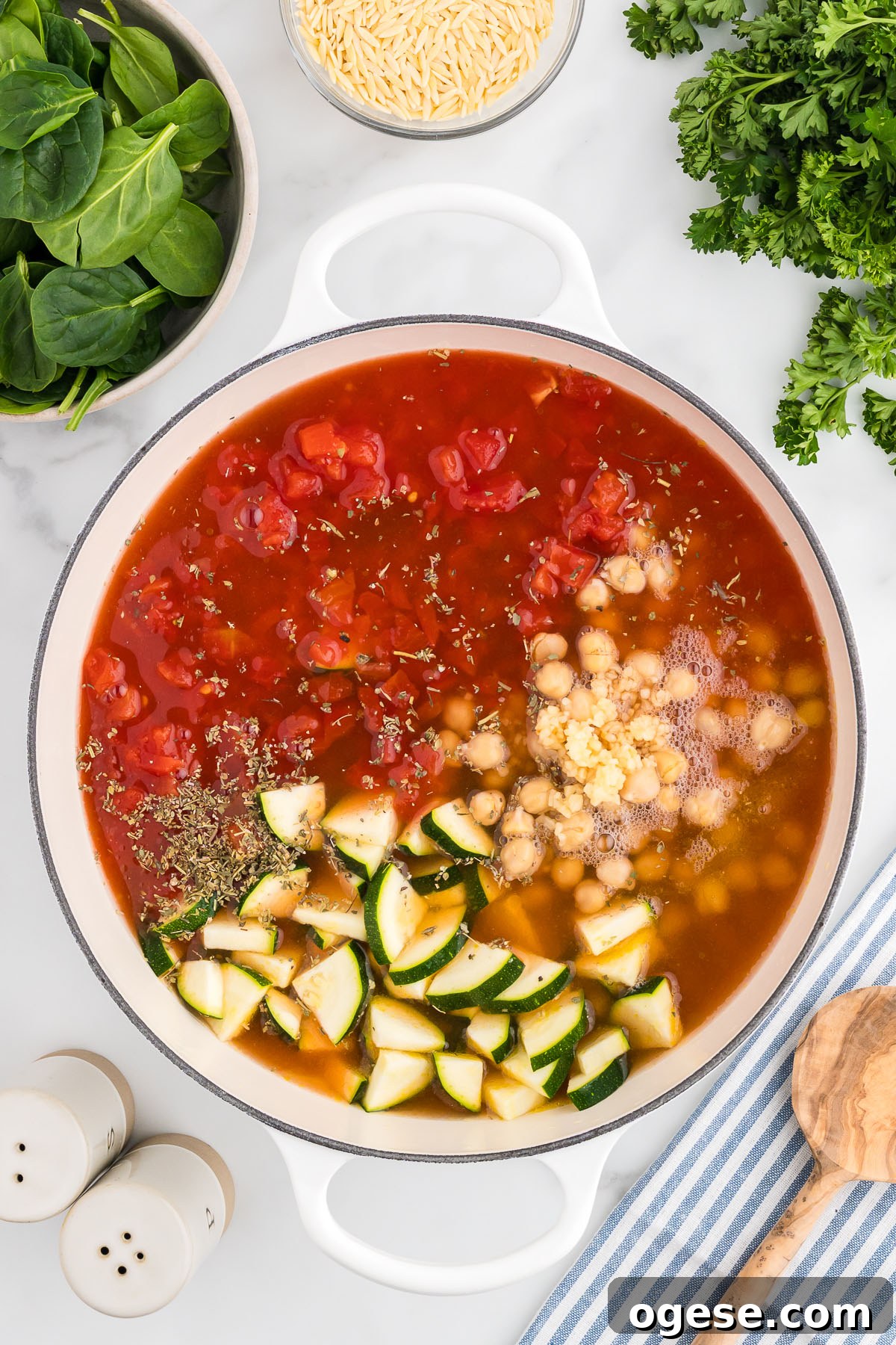 Hearty Vegetable Orzo Soup Recipe for Cozy Weeknights 6 Vegetable broth is added to the vegetables and beans in the large pot.