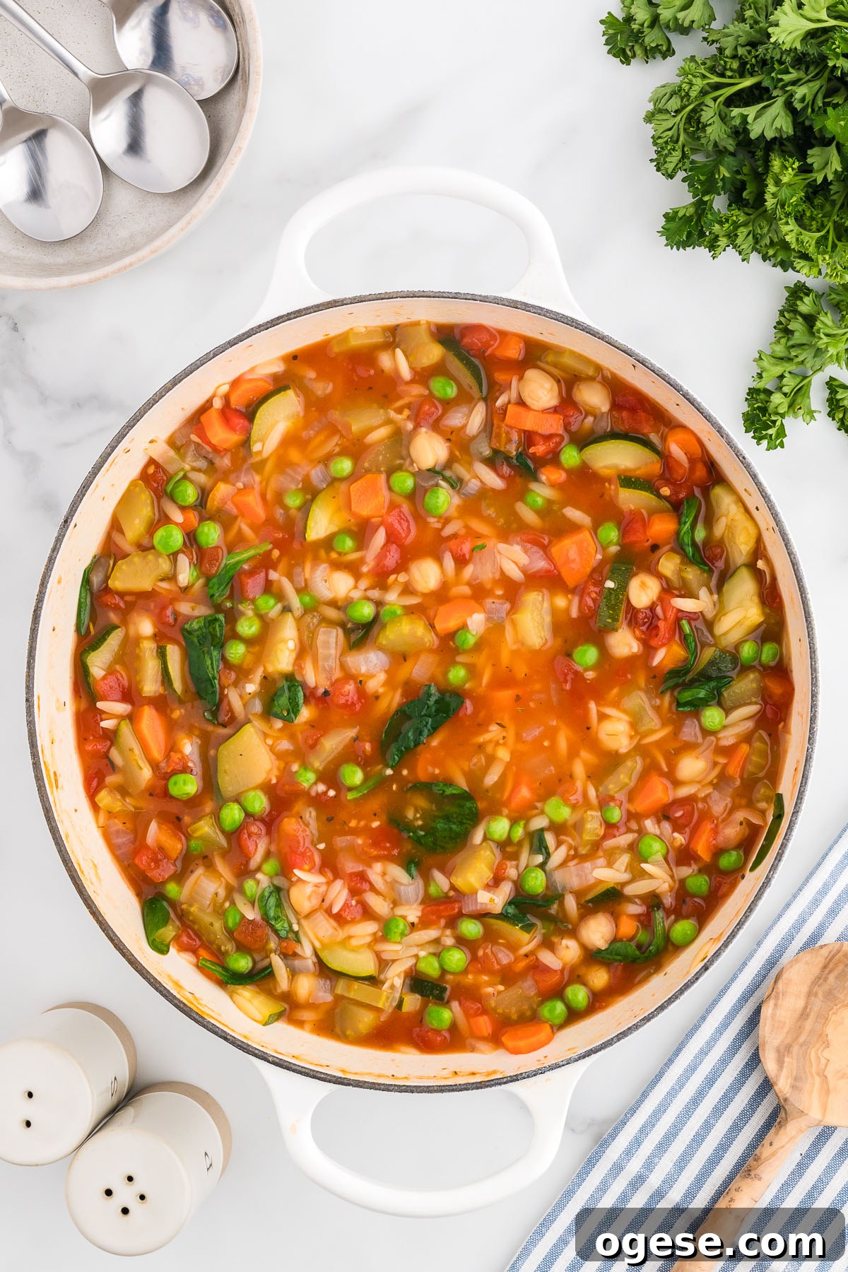 Hearty Vegetable Orzo Soup Recipe for Cozy Weeknights 9 Vegetable orzo soup in a large pot is ready to serve.