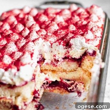 Close up shot of the pan of cherry almond tiramisu with a few slices removed.