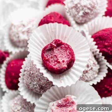 Close up shot of a raspberry brigadeiro with a bite removed