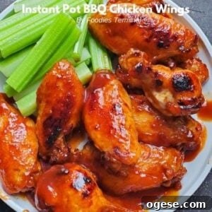instant pot bbq chicken wings served on a white plate with celery sticks