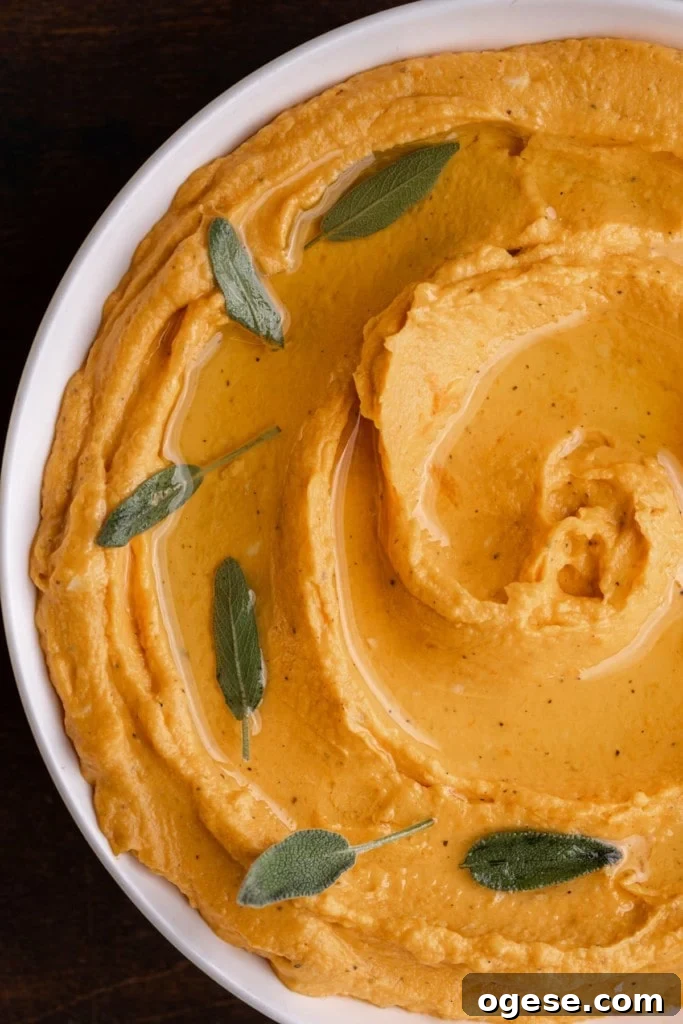 close up of sweet potato hummus garnished with sage