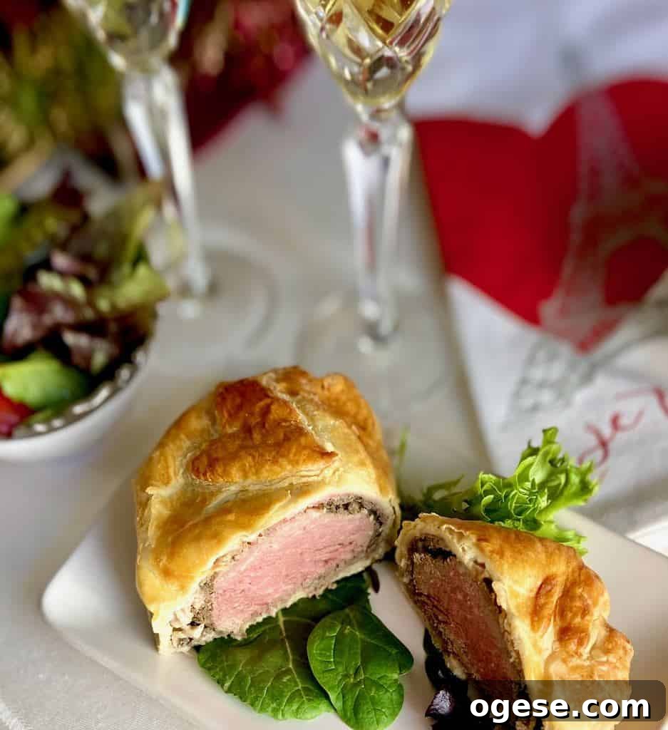 Individual Beef Wellington Recipes and Tips for Perfect Portions 4 Sliced Beef Wellington on white plate.