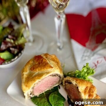 Individual Beef Wellington Recipes and Tips for Perfect Portions 5 Sliced Beef Wellington on white plate.