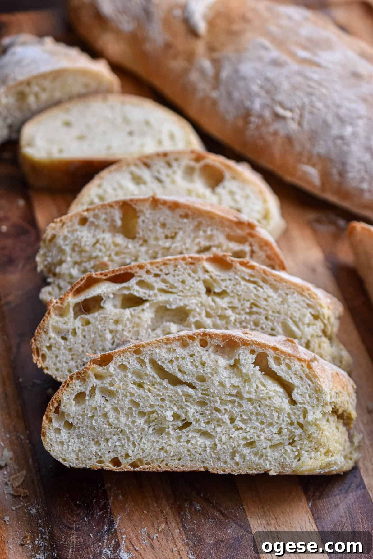 How to Make Crispy-Outside, Airy Ciabatta at Home 2 The slices of ciabatta bread are laid out in front of a loaf of bread.