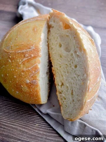 The same day sourdough bread is on a tan napkin cut in half.