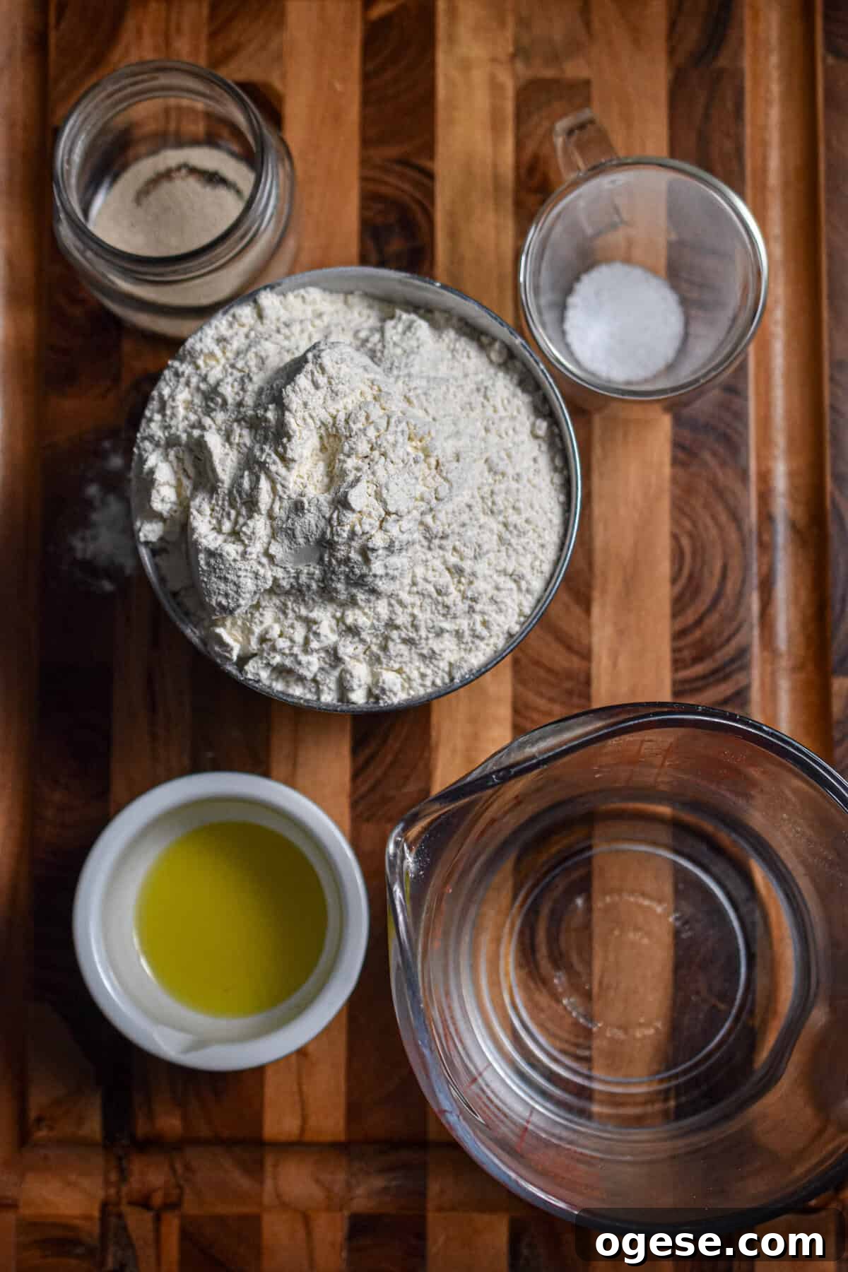 How to Make Crispy-Outside, Airy Ciabatta at Home 3 The ingredients for the ciabatta loaf are laid out on a wooden cutting board.