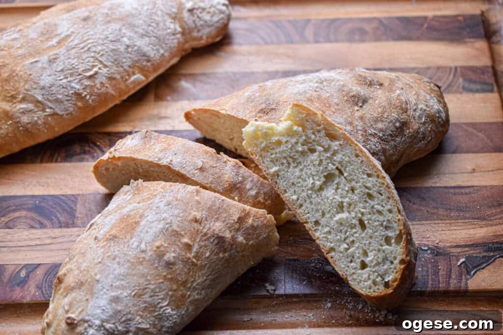 How to Make Crispy-Outside, Airy Ciabatta at Home 9 The ciabatta loaf is mostly together but there are two slices cut out of the middle.
