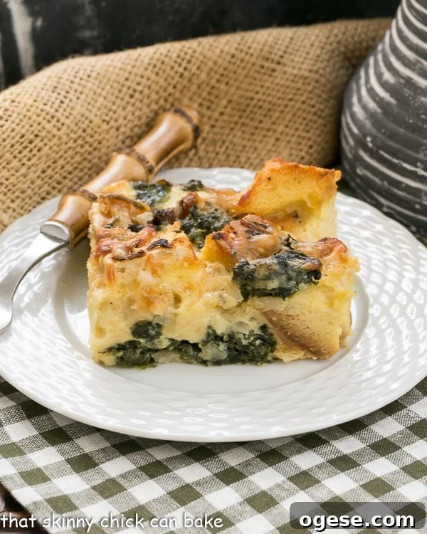 Gruyère and Spinach Strata Recipe for Brunch or Holiday Breakfast 4 A square of spinach egg casserole on a small white plate on a green and white checked napkin.