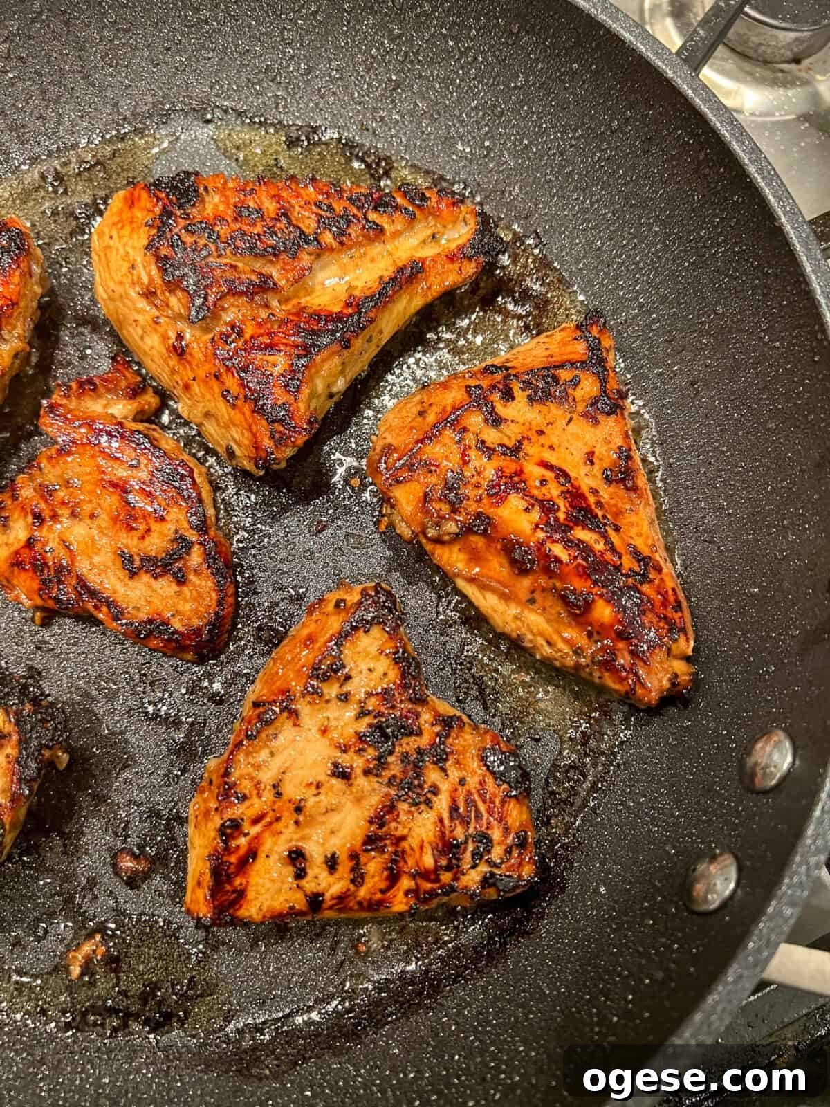 Balsamic marinated chicken cooking in a skillet Balsamic marinated chicken cooking in a skillet
