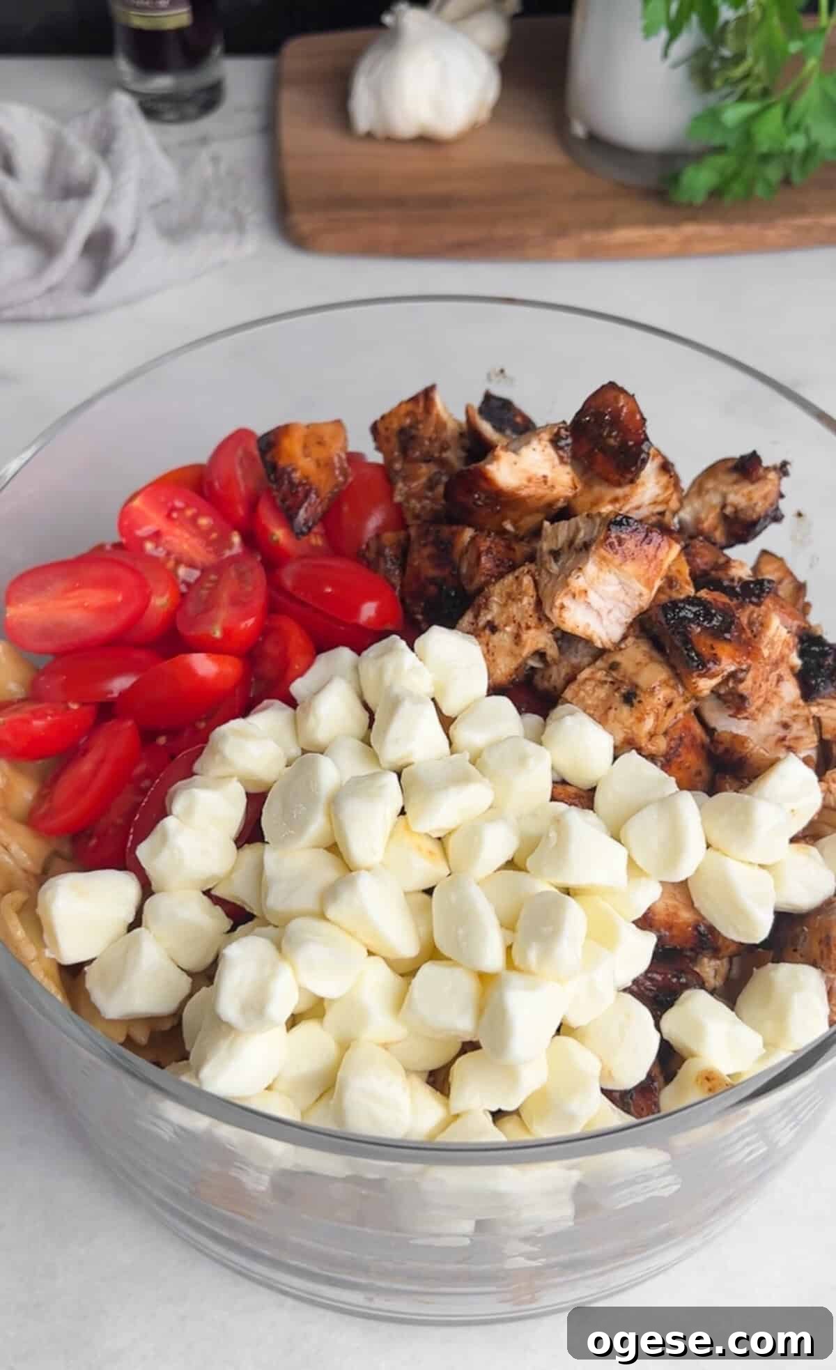 Tomatoes, chicken, and mozzarella in a bowl Grape tomatoes, chicken, and mozzarella pearls in a glass bowl