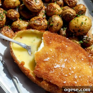 Crispy Fried Cheese Wheel Recipe: Gooey Center, Crunchy Crust 6 Fried soft cheese wheel with golden crust and roasted baby potatoes arranged around it.