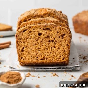 Pumpkin Streusel Bread: Moist Spiced Loaf with Crunchy Topping 4 Sliced pumpkin streusel bread with spices around it.