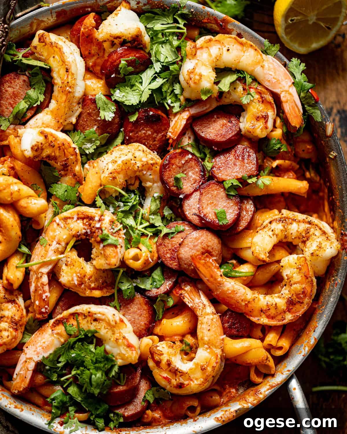 up close photo of cajun shrimp and sausage pasta in a pan. 
