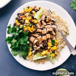 Protein-Packed Chicken and Quinoa Bowl with Veggies 3 Delicious quinoa chicken bowl with fresh mango salsa and cilantro on the side.