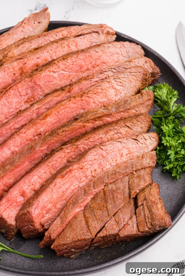 Crispy Air Fryer New York Strip Steak Recipe 9 Flank steak sliced and served on a platter.
