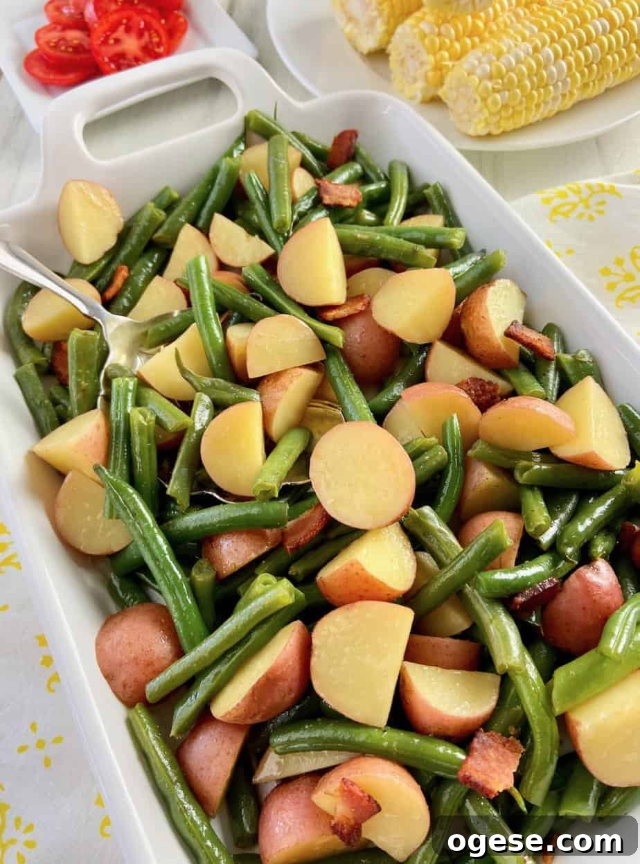Southern-Style Green Beans with New Potatoes 2 Beans and potatoes on white serving platter.