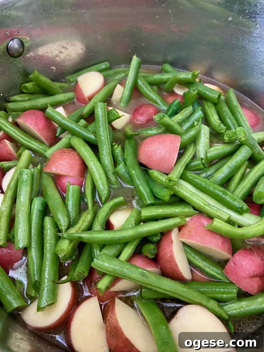 Southern-Style Green Beans with New Potatoes 7 Beans and potatoes in cooking pot.
