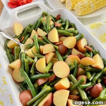 Southern-Style Green Beans with New Potatoes 9 Green beans and potatoes in white serving dish.