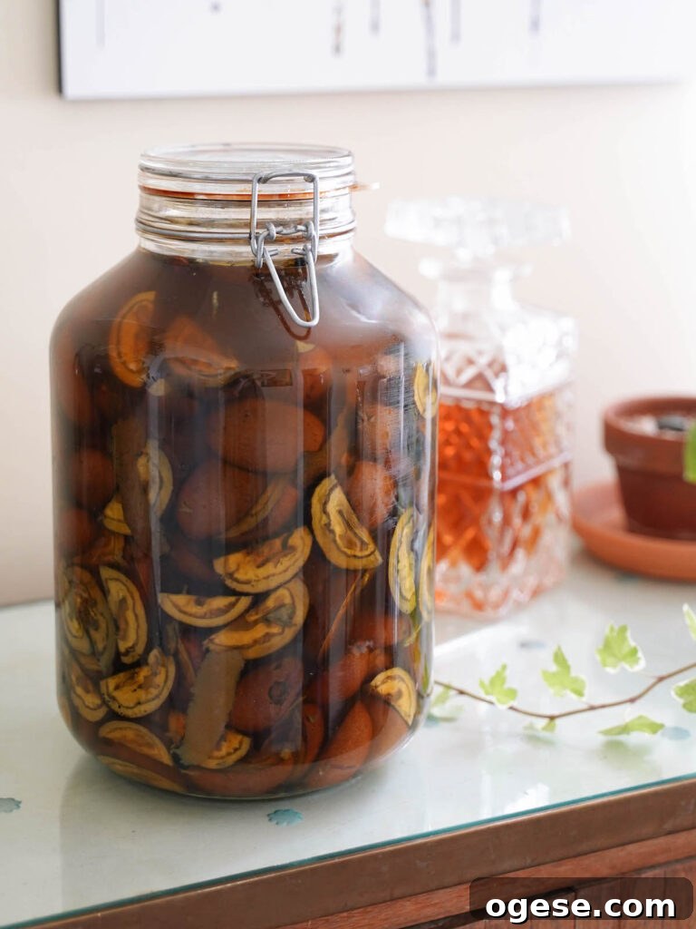 Nocino Cocktail: Crafting a Black Manhattan with Walnut Liqueur 3 A jar of nocino macerating
