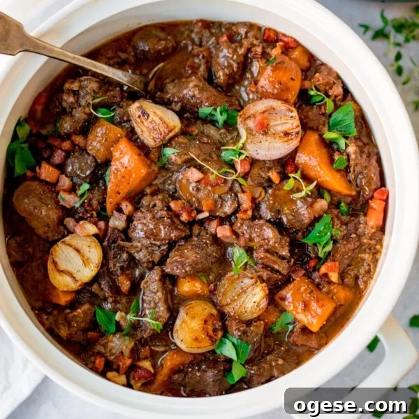 A white pot filled with beef bourguignon