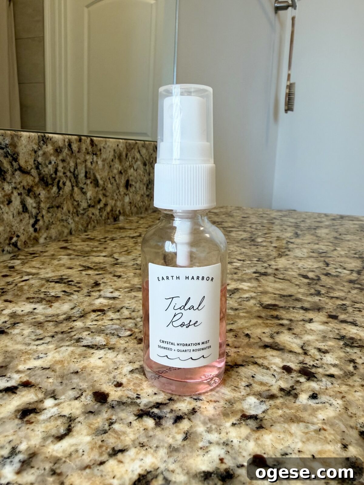 Earth Harbor Skincare Review: Real Pros, Cons, and Results 4 Clear glass spray bottle of Earth Harbor "Tidal Rose" Crystal Hydration Mist, filled with a pink liquid