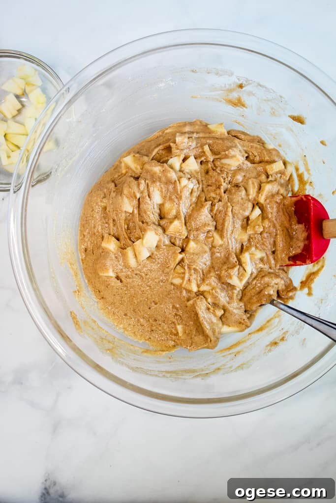 gluten free apple muffins mixed in a glass bowl