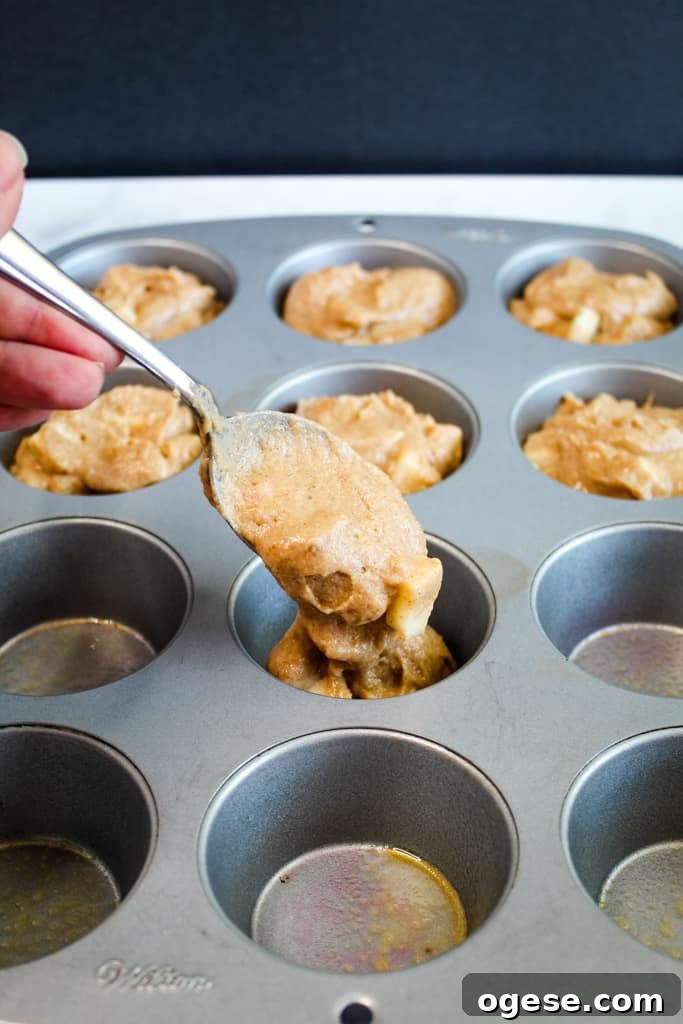 gluten free apple muffins portioned in a muffin tin