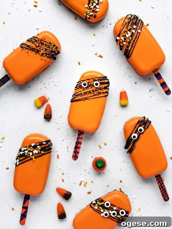 Spooky Halloween Cakesicles: Fun No-Bake Party Treats 3 Orange coated cakesicles