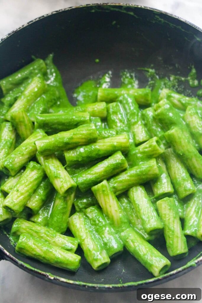 15-Minute Super Green Rigatoni Recipe for Quick Weeknight Dinner 11 Green pasta sauce with rigatoni in a small black pan.
