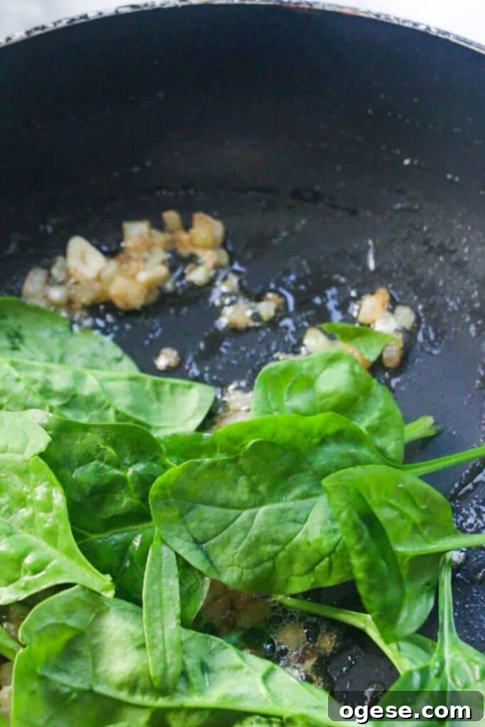15-Minute Super Green Rigatoni Recipe for Quick Weeknight Dinner 6 Spinach added to a small pan with shallot.
