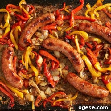 Sheet pan sausage and peppers and onions after they've been baked in the oven.