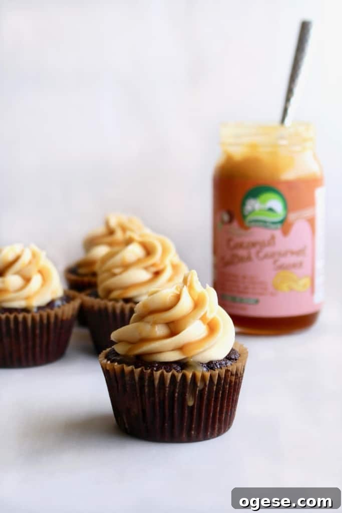 Vegan salted caramel chocolate cupcakes with glossy frosting and caramel drizzle