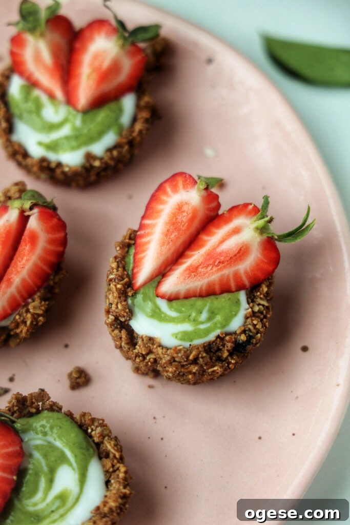 A plate of strawberry matcha granola tarts.
